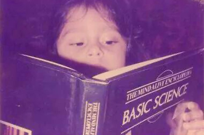 Behold the wise lil one Old photograph of a young girl reading a book